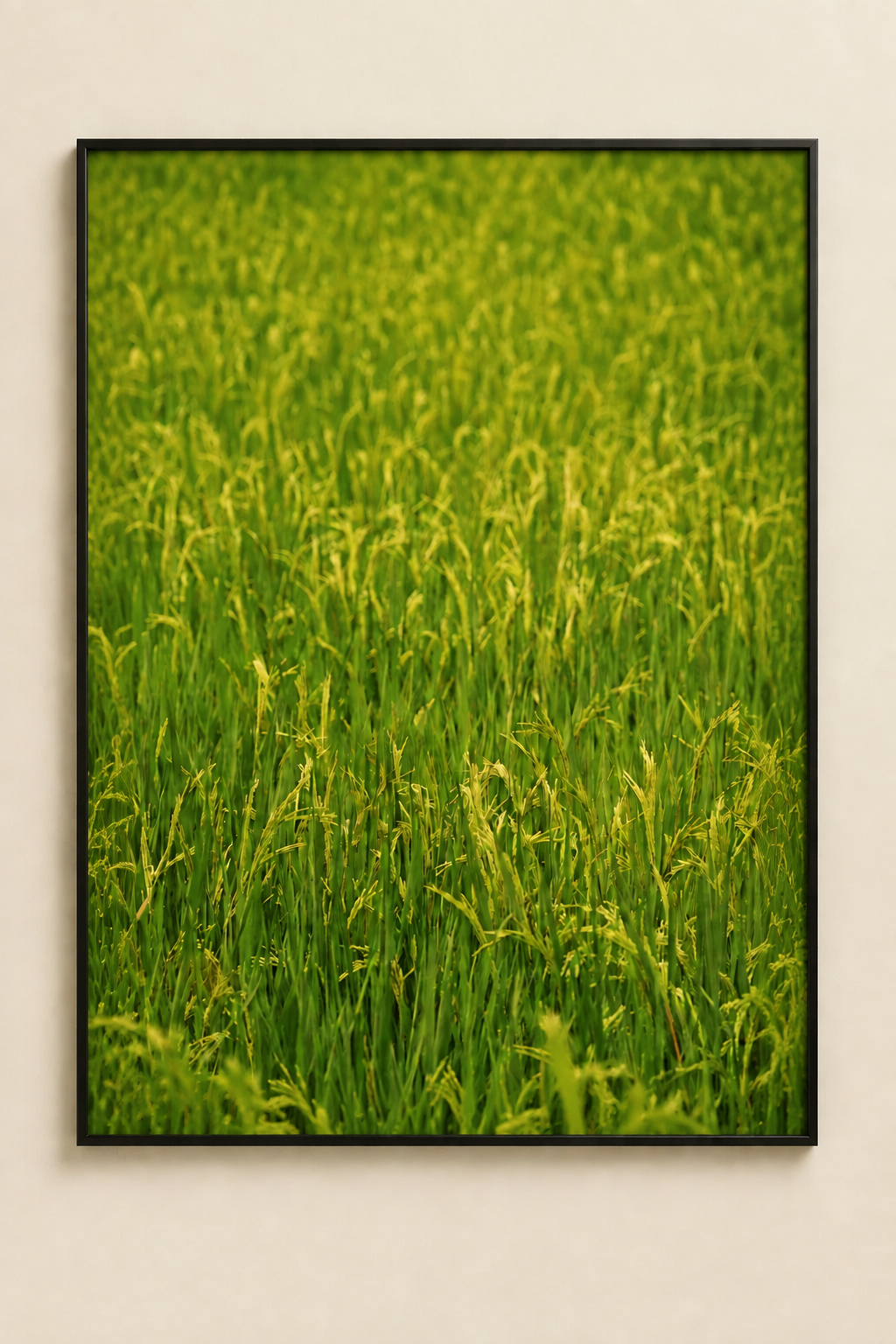 Vibrant green rice-field print filling a thin black frame without a white border on a cream wall
