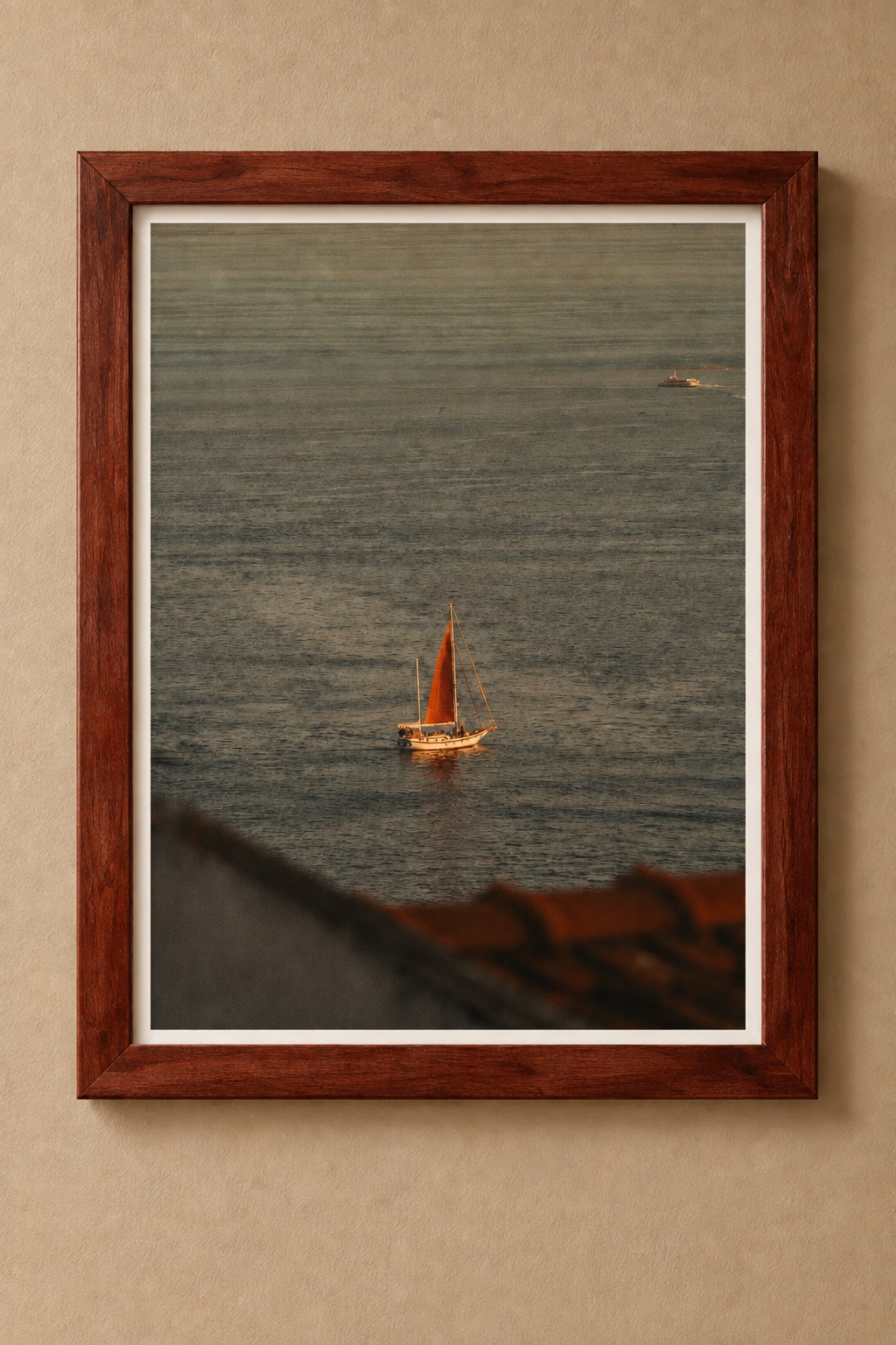 Sailboat with an amber sail on rippling water, displayed in a reddish-brown wooden frame with a white border