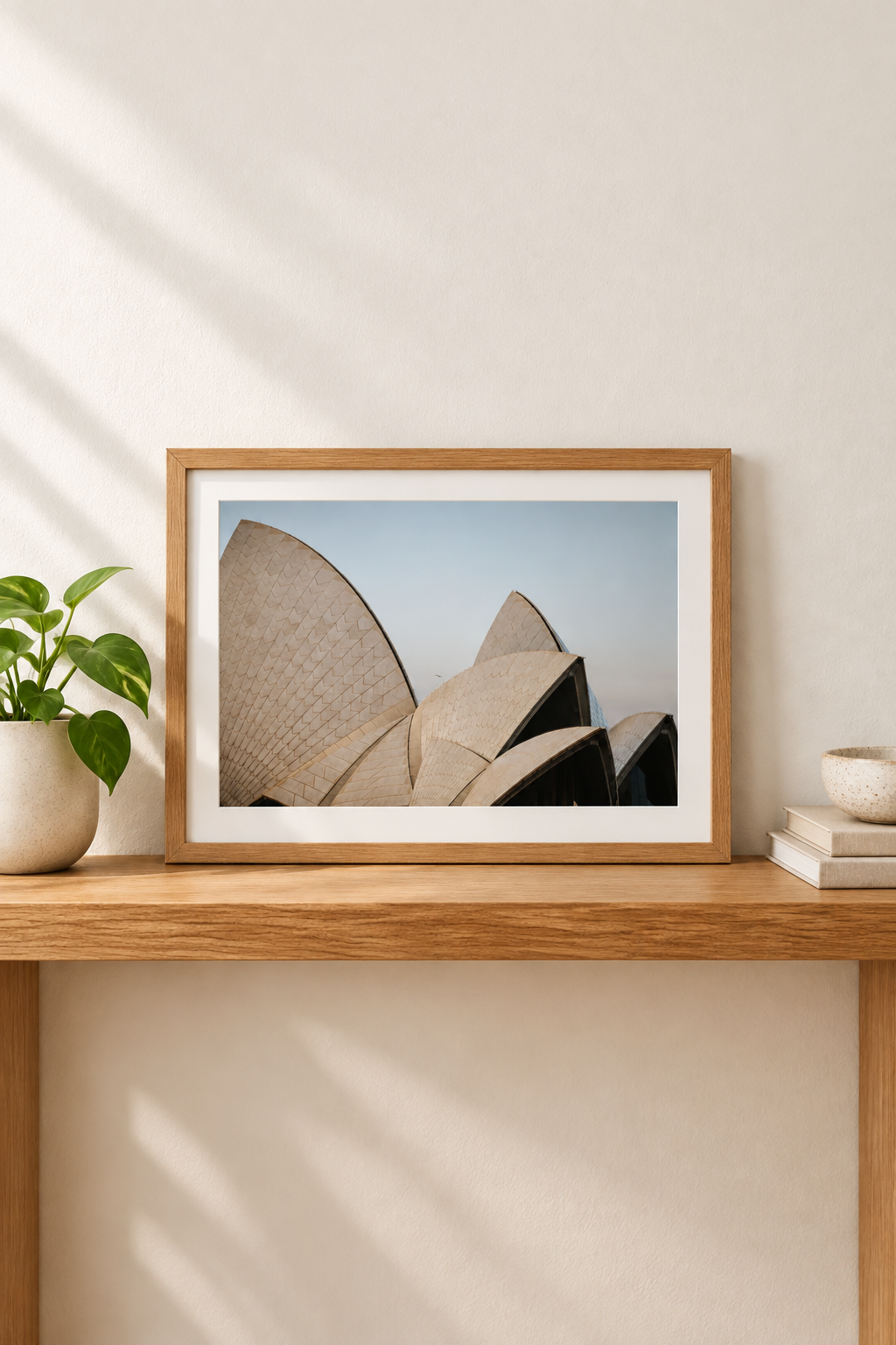 Horizontal framed Sydney Opera House photograph with white border in a vertical console setting