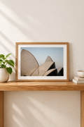 Horizontal framed Sydney Opera House photograph with white border in a vertical console setting