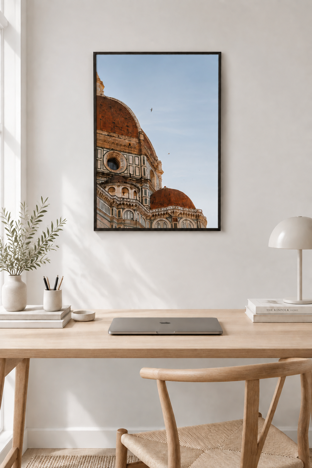 Flight over Florence print without a white border in a black frame above a sunlit desk
